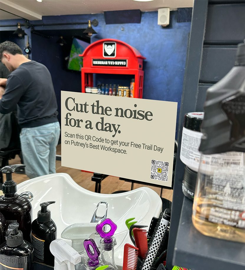 A counter card for a local workspace on a barbershop counter