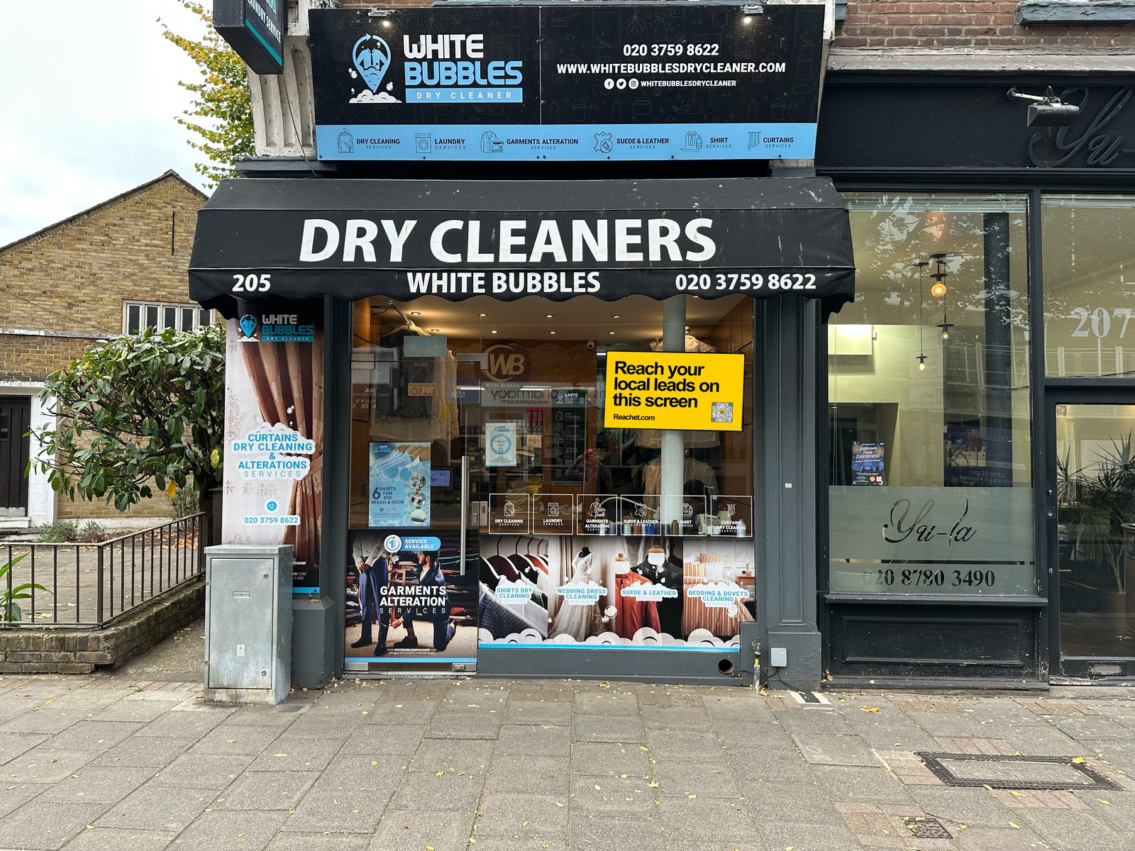 A Reachet window card in the door of White Bubbles Dry Cleaners, 205 Lower Richmond Road